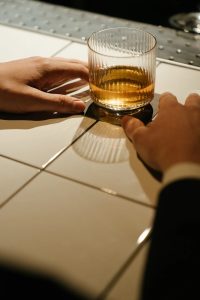 Person Holding Whisky Drinking Glass 